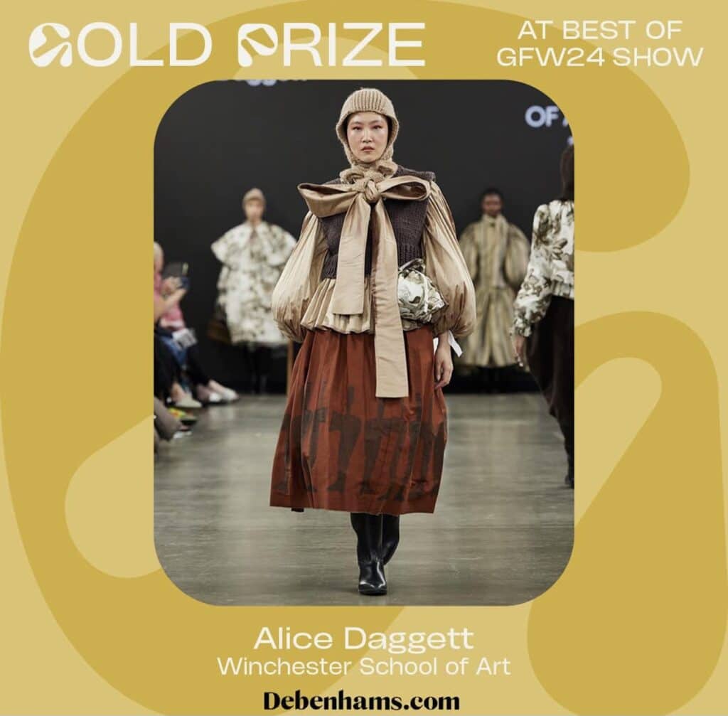 Model on runway wearing a brown skirt, beige top with a large bow, and a knitted cap. Others in similar attire in the background. Text overlays with "Gold Prize," "Alice Daggett," and event details.