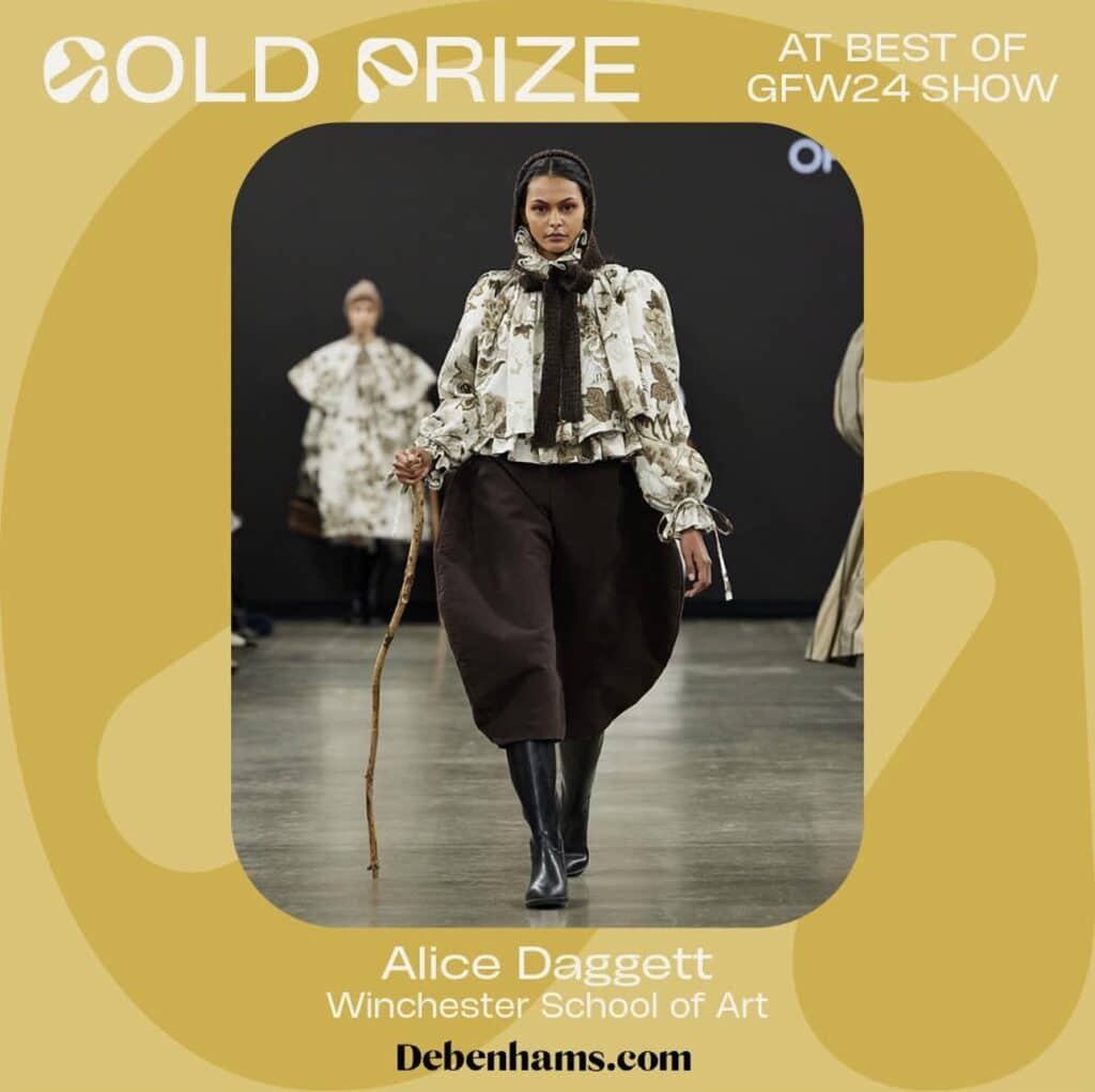 Model wearing a floral blouse and brown skirt walks the runway at GFW show. Text overlay highlights the Gold Prize win by Alice Daggett from Winchester School of Art.