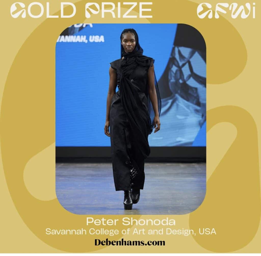 Model in a black dress, walking on a runway with a blue background. Text reads: "GOLD PRIZE AFWI," "Peter Shonoda, Savannah College of Art and Design, USA," and "Debenhams.com.