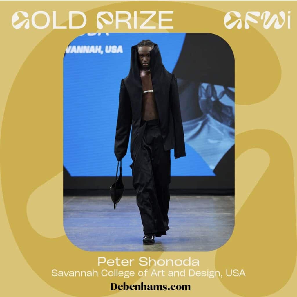 Model walking on a runway, wearing a black outfit with a hood and carrying a small bag. Text on image highlights a "Gold Prize" award at AFWI, with details about the designer's background.